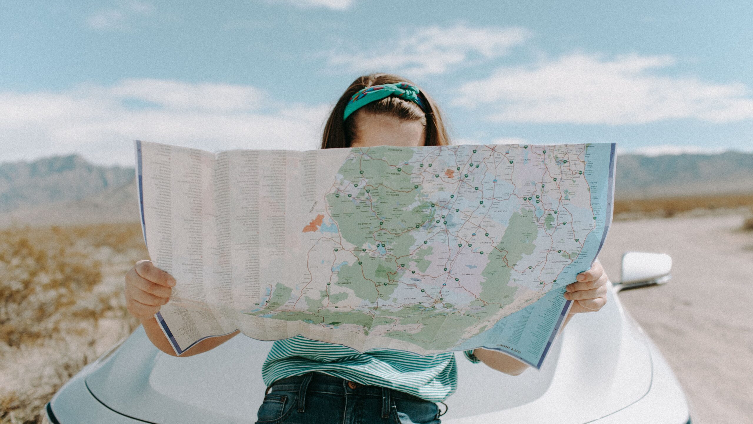 A woman looking at her map as she planes her gluten-free travel route.